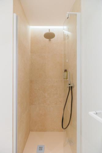 a bathroom with a shower with a glass door at Maison Sirolo in Sirolo