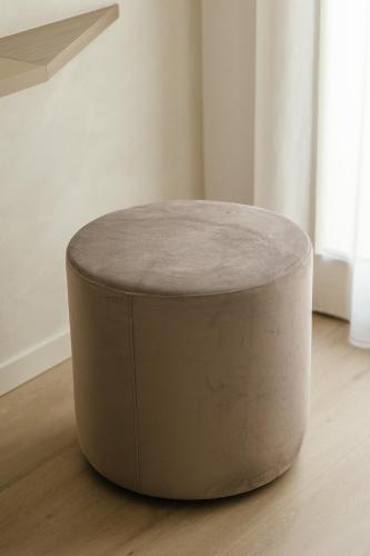 a round ottoman sitting on the floor in a room at Maison Sirolo in Sirolo
