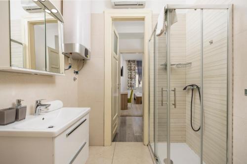 a bathroom with a shower and a sink at Fluminis rooms in Rijeka