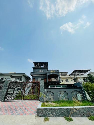 a building with a fence in front of it at Twin City Club in Rawalpindi