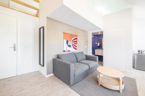 a living room with a couch and a table at Lisbon Oriente Suites by Olala Homes in Lisbon