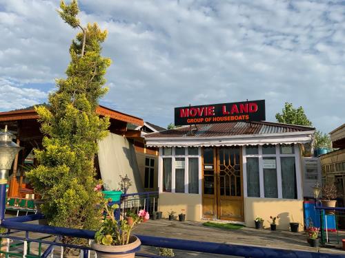 a movember land store with a christmas tree in front of it at Movie land group of house boats in Srinagar