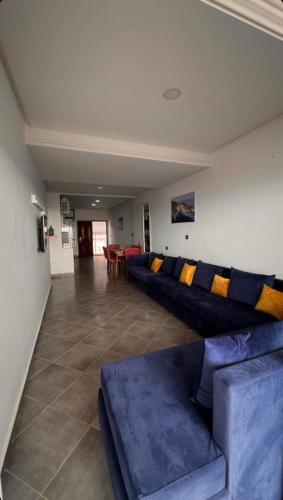 a living room with a blue couch and chairs at Rays View Moulay Bousselham in Moulay Bousselham
