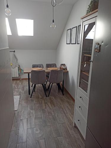 a dining room with a table and two chairs at Agroturystyka u Tadka in Klęczany