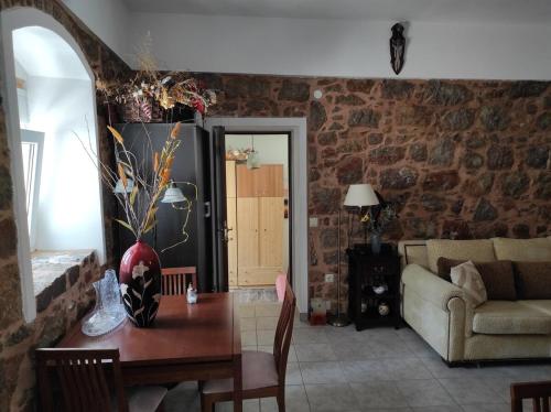 a living room with a table and a couch at Accommodation in Lithi in Chios
