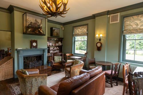 a living room with a couch and a fireplace at The Manners Sleeps 20 Private Bar Dining in Croxton Kerrial