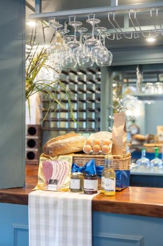 a table with a sandwich and eggs and bread at The Manners Sleeps 20 Private Bar Dining in Croxton Kerrial