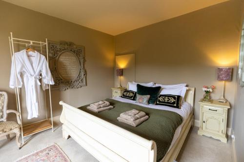 a bedroom with a bed with towels on it at The Manners Sleeps 20 Private Bar Dining in Croxton Kerrial