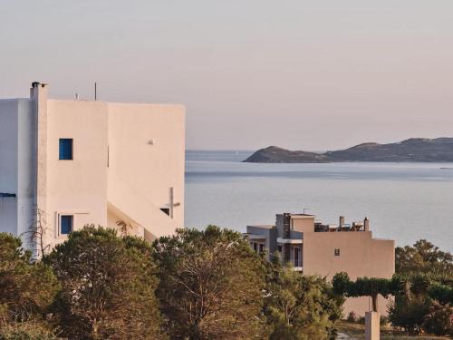 a building on a hill next to a body of water at Ethirenia in Karistos