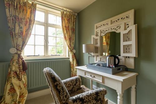 a room with a desk and a mirror and a chair at The Manners Sleeps 20 Private Bar Dining in Croxton Kerrial