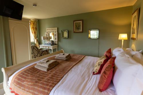 a bedroom with a large bed with towels on it at The Manners Sleeps 20 Private Bar Dining in Croxton Kerrial