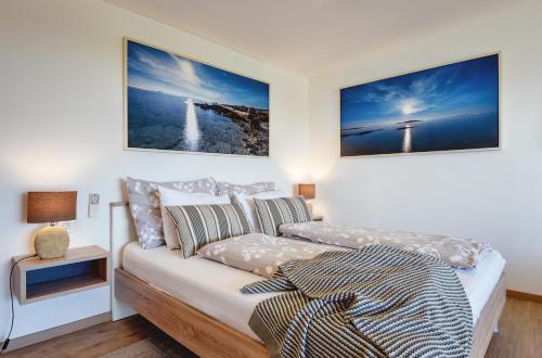 a bedroom with a couch and two pictures on the wall at Villa Klen for 15 people near Pula with jacuzzi and children playgorund in Pula