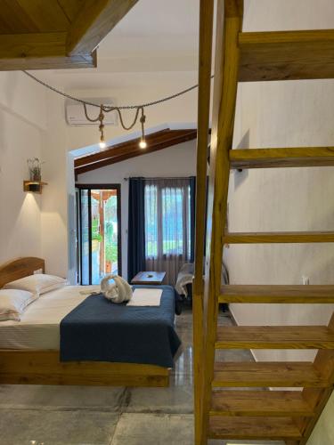 a bedroom with a bunk bed with a cat laying on it at Pinelopi’s House in Porto Koufo