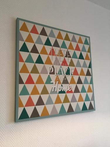 a picture of a wall hanging on a wall at Home sweet Home by Victoria in Aix-les-Bains