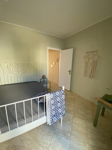 a bedroom with a bed and a table in a room at Violeta in Agios Kirykos