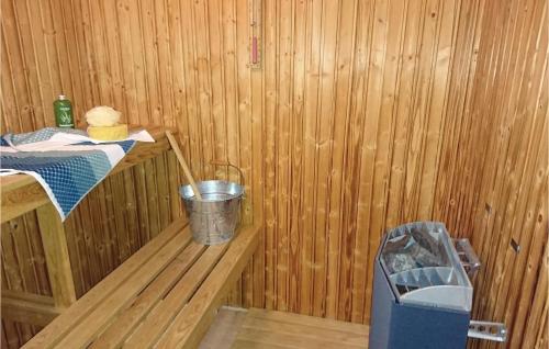 a small wooden room with a bucket in a sauna at Nice Home In Tranås With Kitchen in Tranås