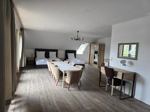 a room with a table and chairs and a bed at Pension Nicole in Bad Bevensen