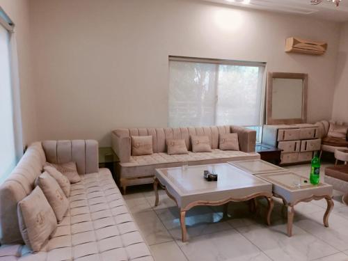 a living room with a couch and a table at Baagh-e-sakoon in Islamabad