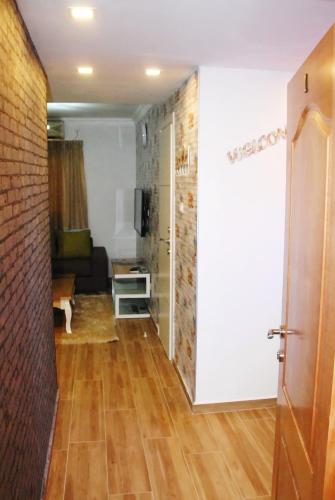 a hallway with a living room with a brick wall at City Apartments in Eilat