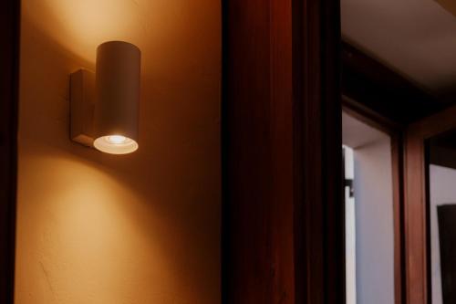 a light hanging on a wall next to a mirror at Palazzo Lucangeli in Porto Recanati