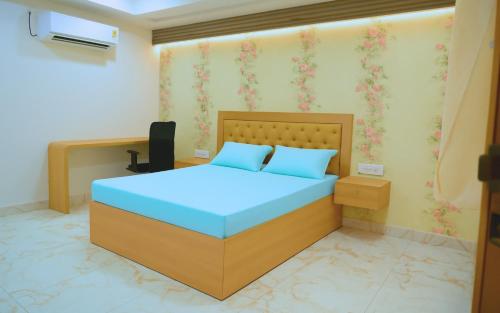 a bedroom with a bed and a desk at Narenn inn studio in Hyderabad