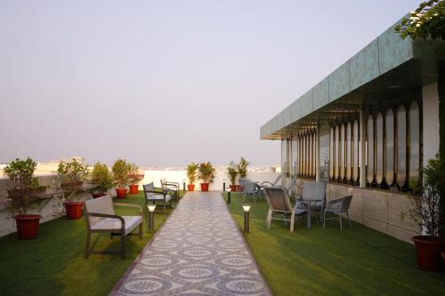 a balcony of a building with chairs and tables at Narenn inn studio in Hyderabad
