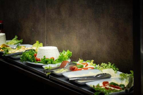 a table with three plates of food on it at Caravel Bike Hotel in Nago-Torbole