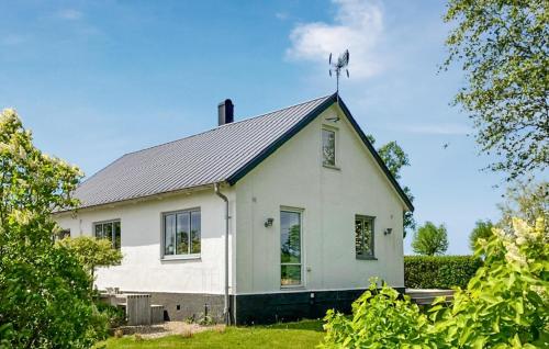 a white house with a metal roof on top of it at Gorgeous Home In Gärsnäs With Wifi in Gärsnäs