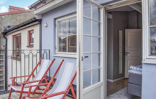 two chairs sitting on a balcony next to a house at 2 Bedroom Lovely Home In Ystad in Ystad