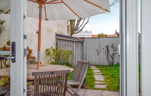 a table and chairs with an umbrella on a patio at 2 Bedroom Lovely Home In Ystad in Ystad