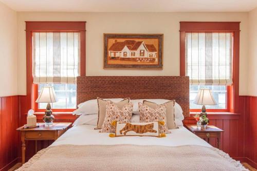 a bedroom with a large bed with two windows at The Cardinal at Buckhorn Hollow in McEwen