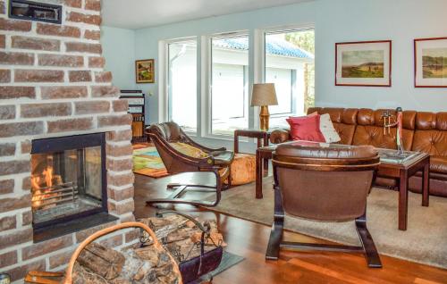 a living room with a fireplace and a couch at Amazing Home In Höllviken With Wifi in Höllviken