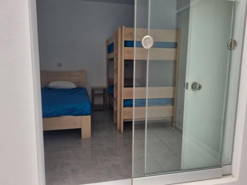 a bedroom with a glass shower and a bed at Bujama beach Home Family Asia in Mala