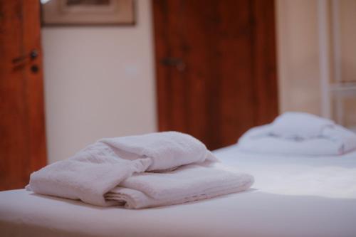 two white towels sitting on top of two beds at Palazzo Lucangeli in Porto Recanati