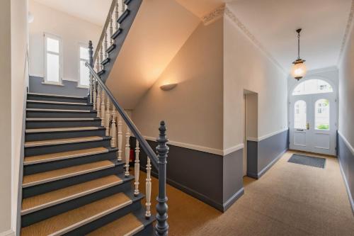 a staircase in a home with a stair case at Villa Carmen Sandburg in Ahlbeck
