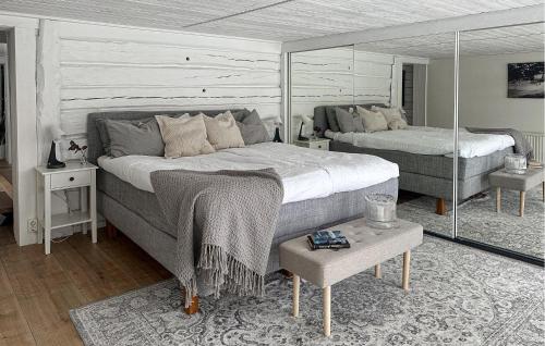 a bedroom with two beds and a table at 2 Bedroom Amazing Home In Gislaved in Gislaved
