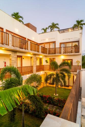an exterior view of a building with palm trees at Aiolos Hotel & Discoveries in Prea