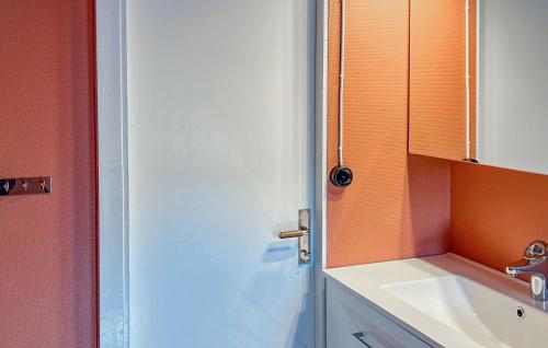 a bathroom with a white sink and a door at 4 Bedroom Beautiful Home In Mönsterås in Mönsterås