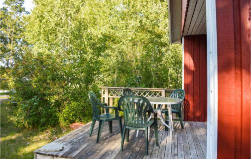a table and chairs sitting on a deck at Cozy Home In Ålem With Kitchen in Ålem