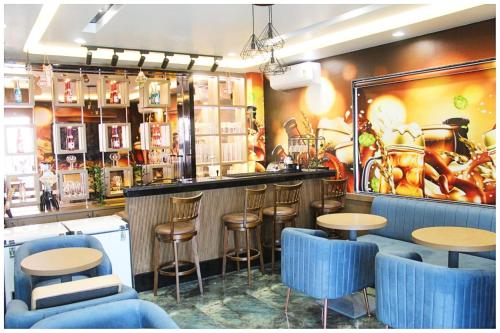 a restaurant with blue stools and a bar at Hotel Moresta Restaurant and Bar Best Facility in Ajmer