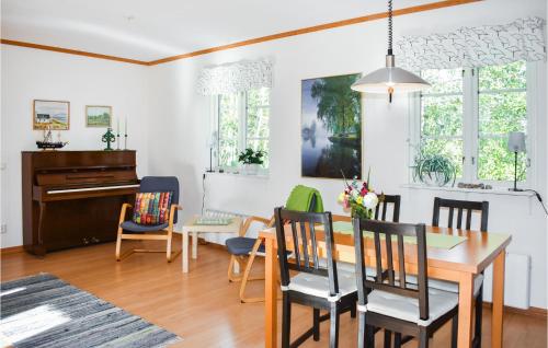 a dining room and living room with a table and chairs at Cozy Home In Ålem With Kitchen in Ålem