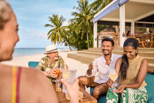 a group of people drinking wine on the beach at ROBINSON MALDIVES - Adults only in Gaafu Alifu Atoll