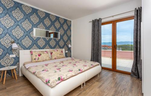 a small bedroom with a bed and a balcony at Holiday home Villa Vrbnik by Villas guide in Vrbnik