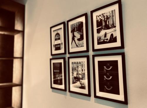 a group of framed pictures hanging on a wall at La Tana Del Ludo in Baveno