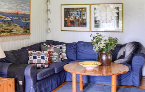 a living room with a blue couch and a table at 3 Bedroom Stunning Home In Borgholm in Borgholm