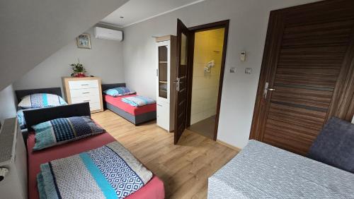 a small room with two beds and a door at Noclegi Mazur przysiersk in Przysiersk
