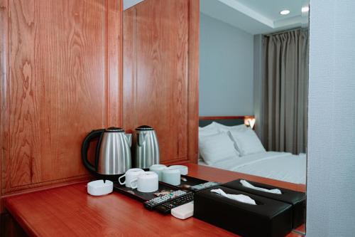 a room with a bed and a desk with a desk at PH Hotel Near SECC Phu My Hung in Ho Chi Minh City