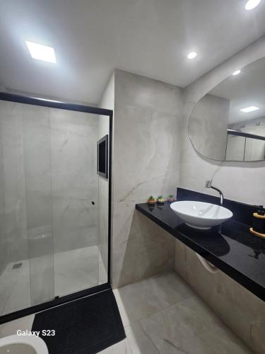 a bathroom with a sink and a shower at Ecoparadise Flat 103 in Caucaia