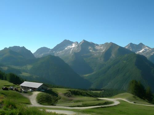 a house on a hill with mountains in the background at Maison du coeur - Bien-être in Challand Saint Anselme