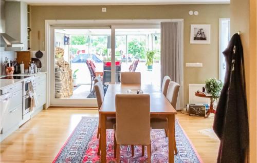 a kitchen and dining room with a table and chairs at 2 Bedroom Gorgeous Home In Hallstavik in Hallstavik